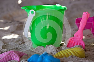 Bucket with moulds and spade on a beach
