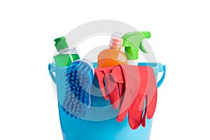 Bucket with objects and cleaning products for wet cleaning, on white, closeup photo