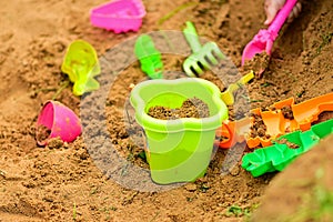 A bucket and a sand set for playing sand on the beach. Holidays with children at the sea. Games and entertainment for young