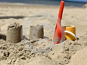 bucket with scoop to build sandcastles on the beach on a summer day