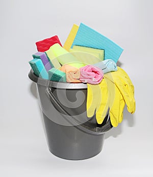 Bucket with tools for cleaning an apartment or office. No one in the photo