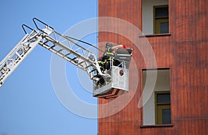 Bucket truck with firefighters during exercise in the firehouse