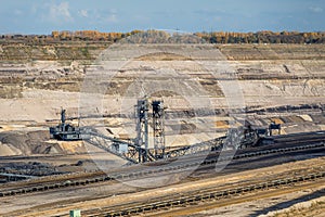 A Bucket-wheel excavator is protruding out of an open cast brown coal pit