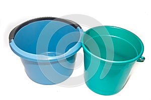 A bucket on a white background. Plastic blue and green bucket on a white background. Bucket for washing floors.