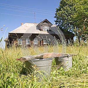 Buckets on the background of a village house