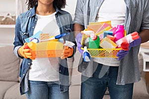 Buckets With Cleaning Supplies In Hands Of Unrecognizable Black Couple