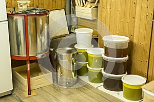 Buckets full of extracted honey out of centrifuge and other Beekeeper equipment