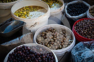 Buckets of olives for sale on Suq or street food market photo