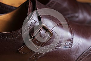 Buckle detail of a pair of classic brown Brogue shoes