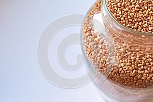 Buckwheat in bank onwhite background. Healthy food. Fresh cereals photo