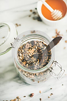 Buckwheat and chocolate granola with hazelnuts in glass jar