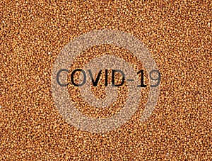 Buckwheat deficiency concept. Coronavirus pandemic concept. Buckwheat groats closeup. Buckwheat texture with the inscription