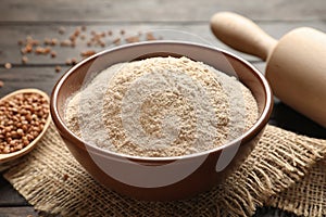 Buckwheat flour in bowl on table