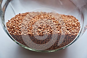 Buckwheat groats in a storage container. Close-up photo