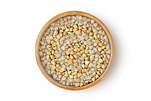 Buckwheat kernels in wooden bowl on white background