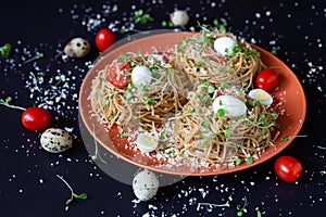 Buckwheat noodles with quail eggs, tomatoes and microgreen. Selective focus