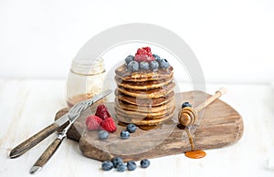 Buckwheat pancakes with fresh berries and honey on