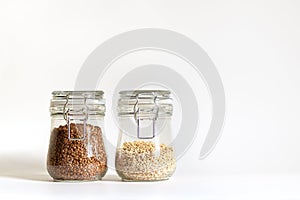 Buckwheat and pearl barley are tightly closed in a glass container. Cereals are stored in banks. Healthy food for