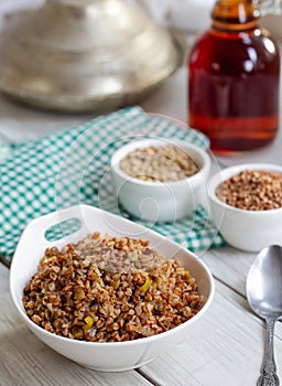 Buckwheat pilaf pilav with vegetable green lentil on wooden background photo