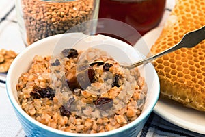 Buckwheat porridge in bowl,seeds and honeycomb.