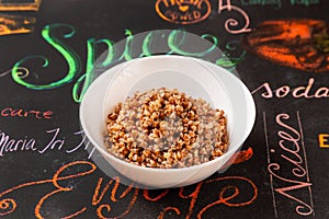 Buckwheat porridge, garnish in a plate on a table