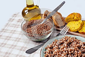 Buckwheat porridge plate bread table yellow brown cereal groats graine cooked boiled oil food