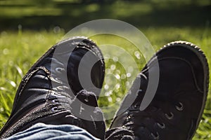 Bucolic black urban trainers over green grass background photo