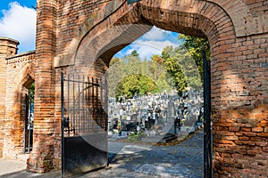 Old brick gate with columns to the city church cemetery