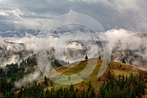 Bucovina autumn landscape in Romania with mist and mountains photo