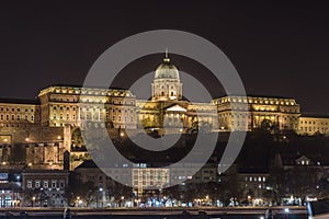 Buda Castle by the Danube river illuminated at night in Budapest, Hungary