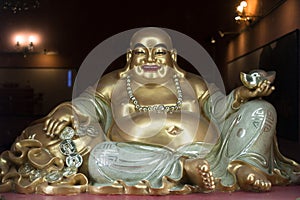 Budai / Hotei, smiling fat and obese buddhist monk photo
