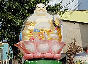 Budai sitting in lotos colorful statue photo