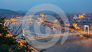 Budapest city at blue hour with illuminated Chain Bridge and Erzsebet Bridge on Danube River, picturesque evening cityscape.