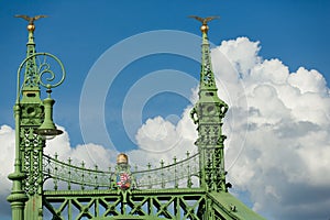 Budapest famous Freedom Bridge detail, green painted iron base, crown and shield with crest, and golden apple with bird