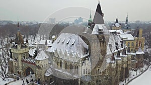 Budapest, Hungary - 4K aerial footage of drone taking of at Vajdahunyad Castle in the snowy City Park