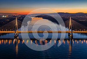 Budapest, Hungary - Aerial drone view of the beautiful illuminated cable-stayed Megyeri Bridge over River Danube at sunset