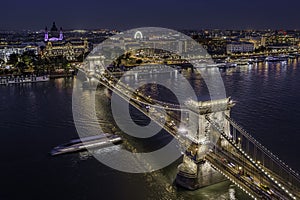 Budapest, Hungary - Aerial drone view of the beautiful illuminated Szechenyi Chain Bridge on a nice summer evening