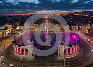 Budapest, Hungary - Aerial drone view of the famous Heroes` Square Hosok tere lit up in unique purple and pink color by night photo