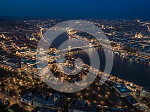 Budapest, Hungary - Aerial drone view of the illuminated Buda Castle Royal Palace at blue hour. Szechenyi Chain Bridge