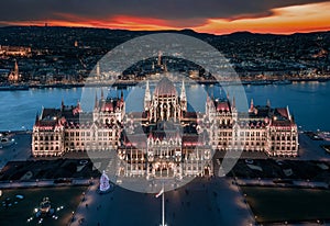 Budapest, Hungary - Aerial panoramic view of the beautiful illuminated Hungarian Parliament building at dusk with Christmas tree