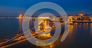 Budapest, Hungary - Aerial panormaic view of the famous illuminated Szechenyi Chain Bridge at blue hour with Parliament building