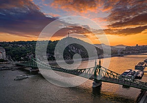 Budapest, Hungary - Aerial skyline view of a beautiful sunset over River Danube and Gellert Hill with sightseeing boat