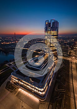 Budapest, Hungary - Aerial vertical panoramic view of Budapests new, illuminated skyscraper at Kopaszi-gat by the riverbank photo