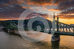 Budapest, Hungary - Aerial view of a beautiful sunset over River Danube with Liberty Bridge, Gellert Hill and Statue of Liberty