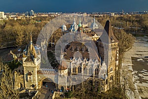 Budapest, Hungary - Aerial view of beautiful Vajdahunyad Castle in City Park at sunset with dark clouds