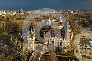 Budapest, Hungary - Aerial view of beautiful Vajdahunyad Castle in City Park at sunset with dark clouds behind