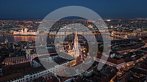 Budapest, Hungary - Aerial view of Buda Castle district at night with illuminated Matthias Church and Fisherman`s Bastion