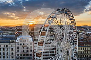 Budapest, Hungary - Aerial view of the famous ferris wheel of Budapest with Buda Castle Royal Palace and an amazing golden sunset