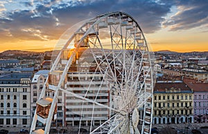 Budapest, Hungary - Aerial view of the famous ferris wheel of Budapest with Buda Castle Royal Palace and an amazing golden sunset