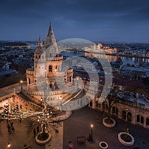 Budapest, Hungary - Aerial view of the famous illuminated Fisherman`s Bastion Halaszbastya with Parliament of Hungary